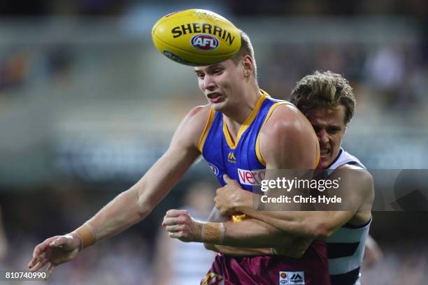 Matthew Hammelmann of the Lions is tackled by Jake Kolodjashnij of the Cats during the round 16 AFL match between the Brisbane Lions and the Geelong...