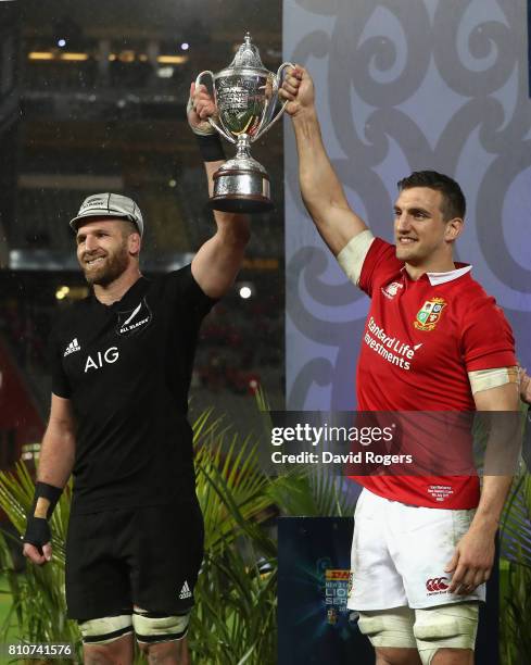 Sam Warburton, the Lions captain, lifts the trophy with Kieran Read, the All Black captain after their sides draw in the final test 15-15 and tie the...