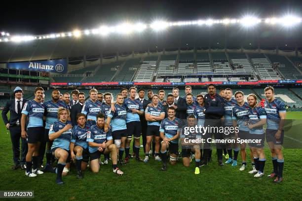 Will Skelton, Rob Horne and Dean Mumm of the Waratahs pose with team mates after playing their last home game for the Waratahs during the round 16...