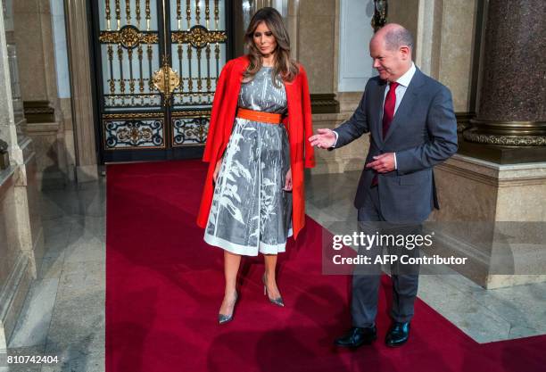 Hamburg's mayor Olaf Scholz greets US First Lady Melania Trump as she arrives to attend the partners' programme at the city hall during the G20...