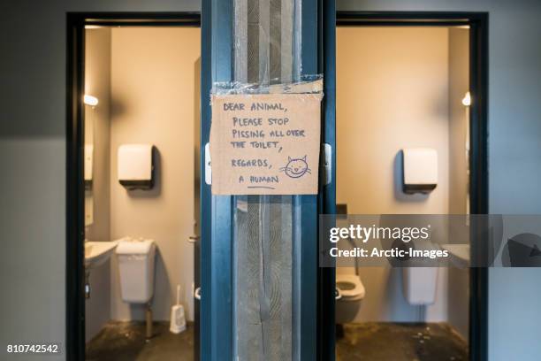 reminder sign posted in a public restroom - toilet sign stock pictures, royalty-free photos & images