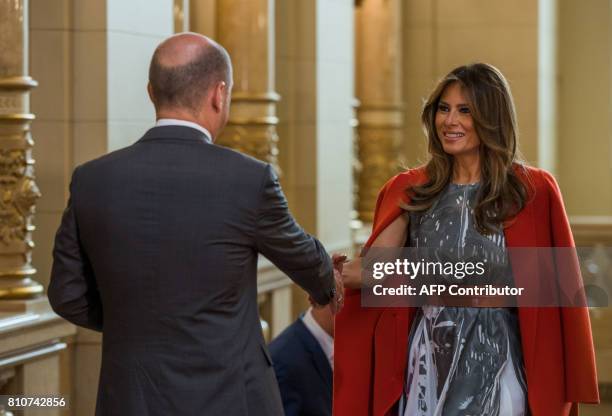 Hamburg's mayor Olaf Scholz greets US First Lady Melania Trump as she arrives to attend the partners' programme at the city hall during the G20...