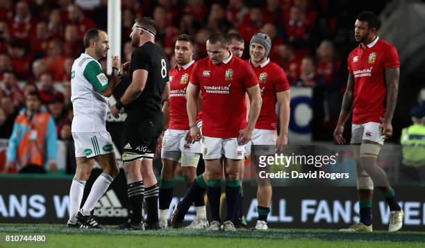 Romain Poite the referee, talks to All Black captain, Kieran Read after he reverses a decision when he orginally had awarded a penalty to the All...