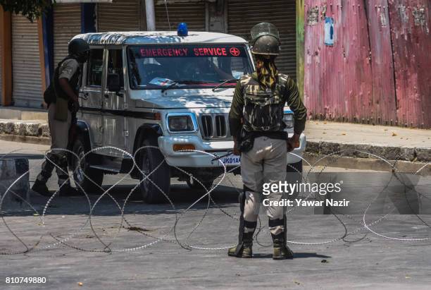 Indian government forces stop an ambulance during a curfew, on the the first death anniversary of Burhan Wani a young rebel commander, on July 8,...
