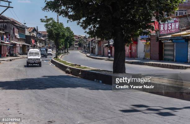Indian government forces patrol the deserted roads in the old city during a curfew, on the the first death anniversary of Burhan Wani a young rebel...