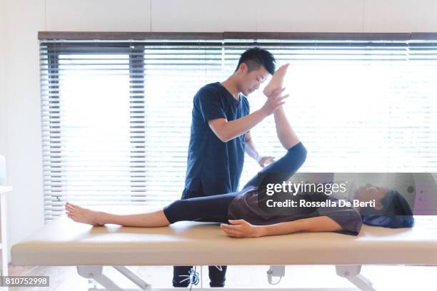 patient receiving chiropractic treatment - osteopath stock pictures, royalty-free photos & images