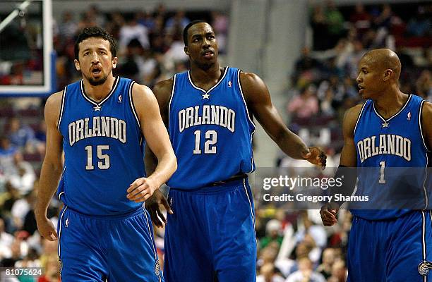 Hedo Turkoglu, Dwight Howard and Maurice Evans of the Orlando Magic walk towards the bench against the Detroit Pistons in Game Five of the Eastern...