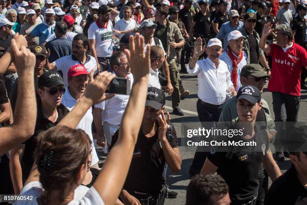 Turkey's main opposition Republican People's Party leader Kemal Kilicdaroglu waves to the crowd as he leads thousands of supporters in the final...