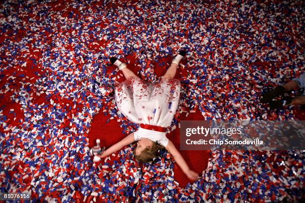 Carly Smith of Charleston, West Virginia, plays in the confetti after a rally for Democratic presidential hopeful Sen. Hillary Clinton at the...