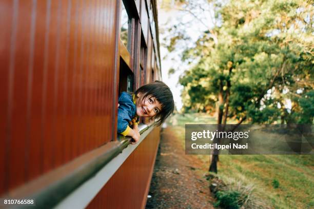 adorable little girl enjoying train ride through countryside - melbourne train stock pictures, royalty-free photos & images