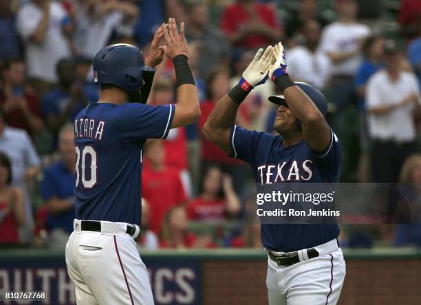 Adrian Beltre and Nomar Mazara of the Texas Rangers celebrate Beltre's three-run home run against the Los Angeles Angels of Anaheim during the second...