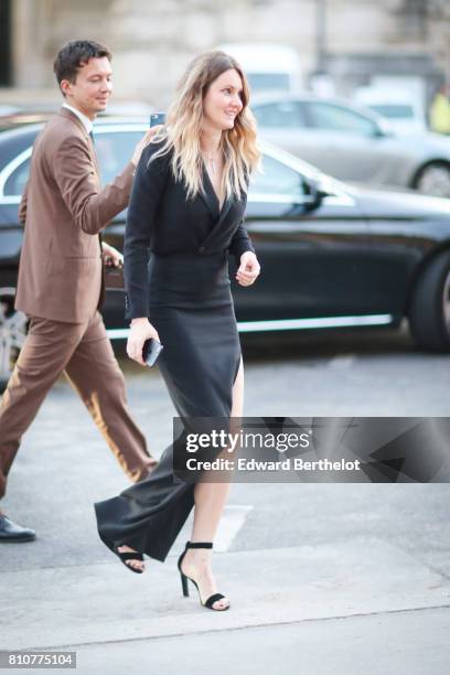 Guest wears a black dress and black heels shoes, outside the amfAR dinner at Petit Palais, during Paris Fashion Week - Haute Couture Fall/Winter...