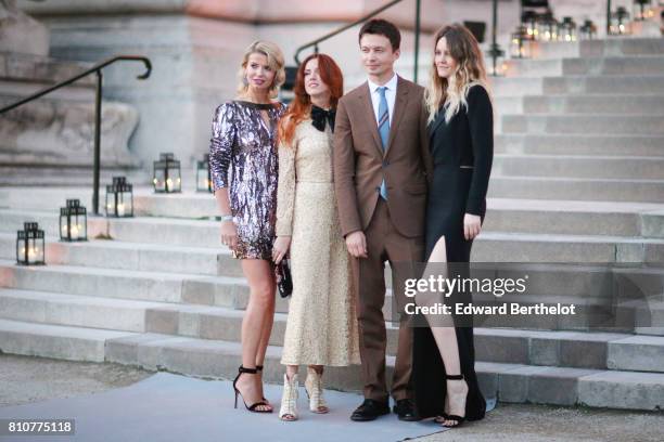 Guests are posing in front of photographers, outside the amfAR dinner at Petit Palais, during Paris Fashion Week - Haute Couture Fall/Winter...