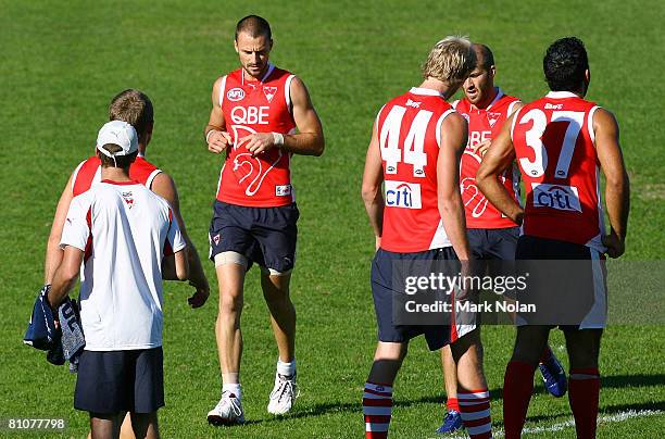 Nick Malceski of the Swans warms up with team-mates during a Sydney Swans AFL training session at the Sydney Cricket Ground on May 14, 2008 in...