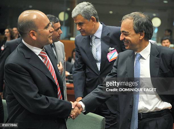 Turkish Economy Minister Mehmet Simsek shakes hand with Cyprus counterpart Charilaos Stavrakis prior to an Ecofin and candidate countries meeting on...