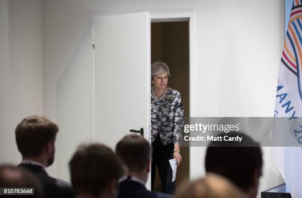 British Prime Minister Theresa May arrives to give a press conference at the end of the second day of the G20 summit on July 8, 2017 in Hamburg,...