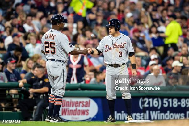 Detroit Tigers second baseman Ian Kinsler gets a fist bump from Detroit Tigers Third Base Coach Dave Clark after advancing to third base on a single...