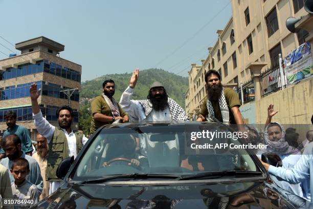 Syed Salahuddin , senior leader of the Kashmiri militant group Hizb-ul-Mujahideen, waves to supporters as he leaves after a rally to mark the first...