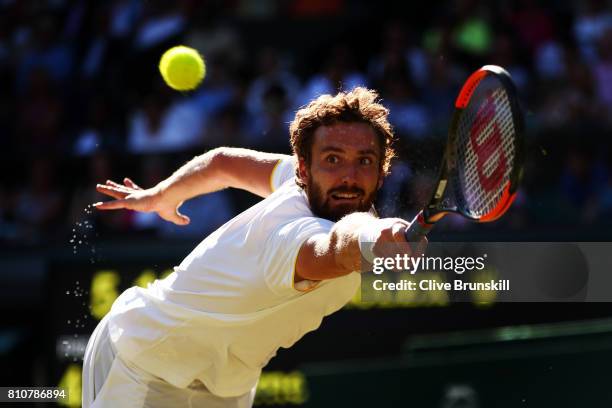 Ernests Gulbis of Latvia plays a backhand during the Gentlemen's Singles third round match against Novak Djokovic of Serbia on day six of the...