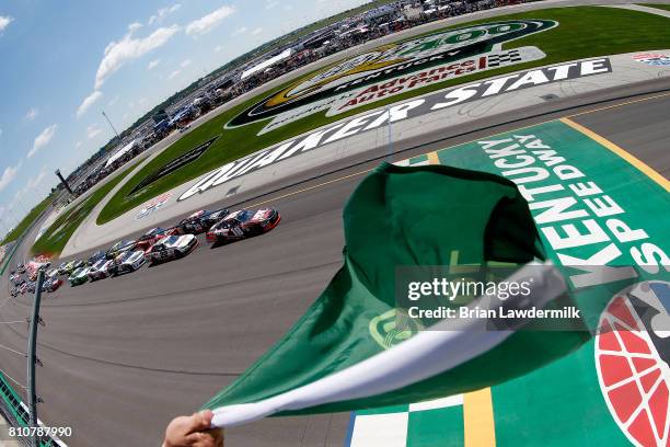 Kyle Busch, driver of the NOS Energy Drink Rowdy Toyota leads the field at the start of the NASCAR XFINITY Series Alsco 300 at Kentucky Speedway on...