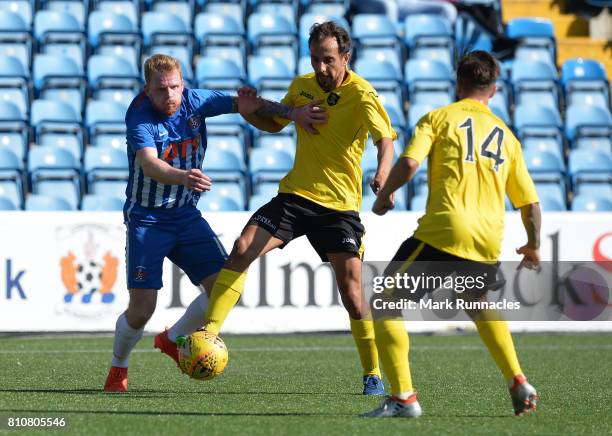 Chris Burke of Kilmarnock is tackled Keaghan Jacobs and Scott Pittman of Livingston during the pre season friendly between Kilmarnock and Livingston...