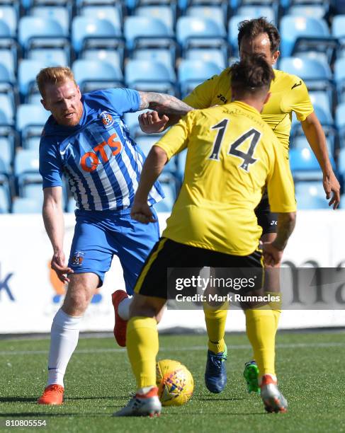 Chris Burke of Kilmarnock is tackled Keaghan Jacobs and Scott Pittman of Livingston during the pre season friendly between Kilmarnock and Livingston...