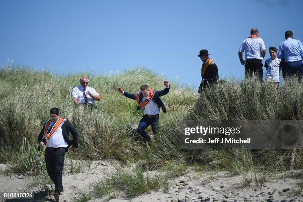 Orangmen take a walk onto the beach as they take part in the annual pre Twelfth of July parade held in Rossnowlagh on July 8, 2017 in Donegal,...