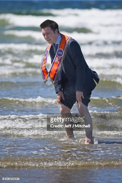 Orangmen take a walk onto the beach as they take part in the annual pre Twelfth of July parade held in Rossnowlagh on July 8, 2017 in Donegal,...