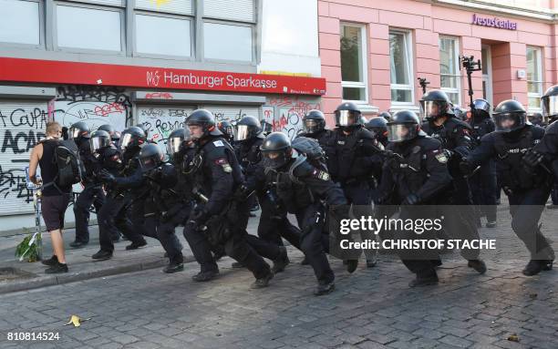 Riot police charge forward towards protesters on July 8, 2017 in Hamburg, northern Germany as world leaders meet during the G20 summit. Raging street...