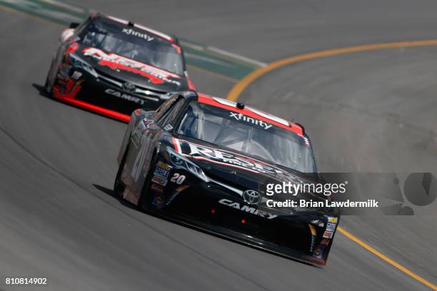 Erik Jones, driver of the Reser's American Classic Toyota, leads Kyle Busch, driver of the NOS Energy Drink Rowdy Toyota, during the NASCAR XFINITY...