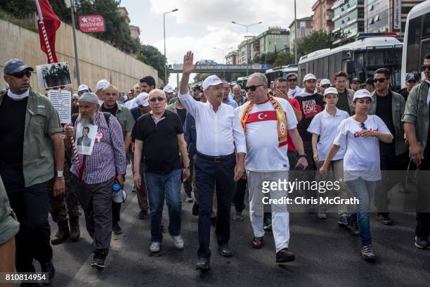 Turkey's main opposition Republican People's Party leader Kemal Kilicdaroglu waves to the crowd as he leads thousands of supporters on day 24 of the...