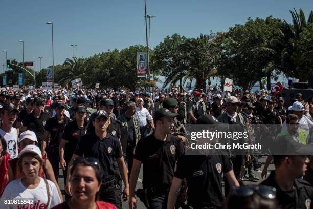 Turkey's main opposition Republican People's Party leader Kemal Kilicdaroglu waves to the crowd as he leads thousands of supporters in the final...