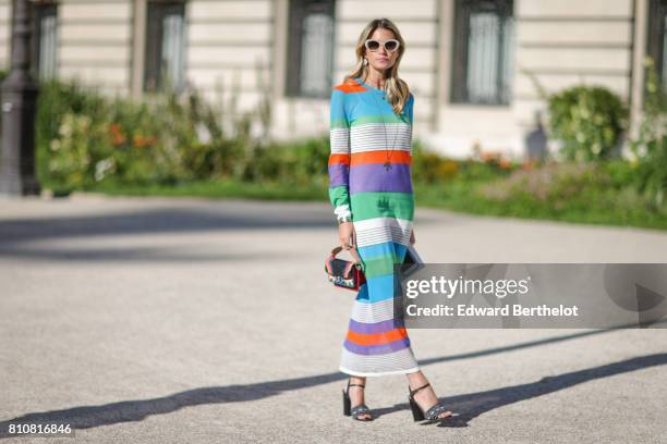 Helena Bordon wears sunglasses, a striped dress, outside the Giambattista Valli show, during Paris Fashion Week - Haute Couture Fall/Winter...