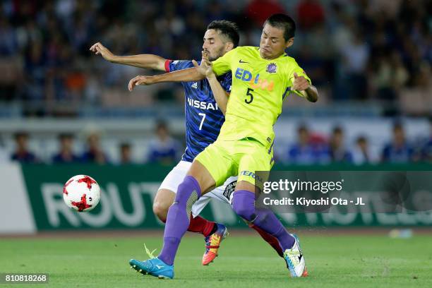 Hugo Vieira of Yokohama F.Marinos and Kazuhiko Chiba of Sanfrecce Hiroshima compete for the ball during the J.League J1 match between Yokohama...