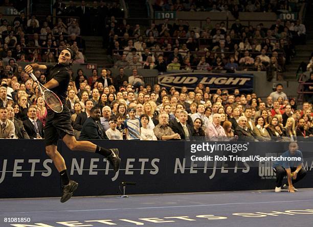 Roger Federer of Switzerland leaps for a shot against Pete Sampras of the USA during their exhibition match on March 10, 2008 at Madison Square...