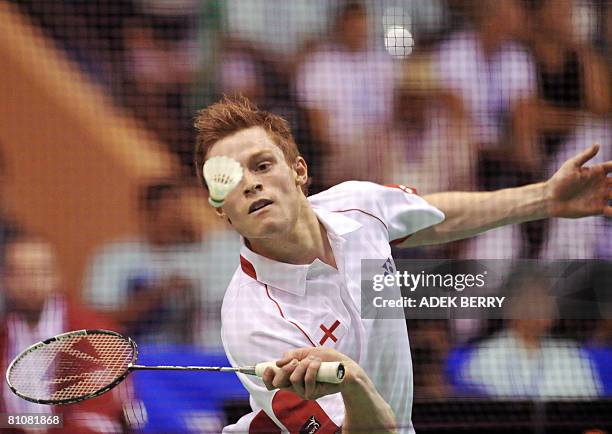 Andrew Smith of England returns the shuttle cock to Indonesian player Sonny Dwi Kuncoro during their quarter-final match of the Thomas cup tournament...