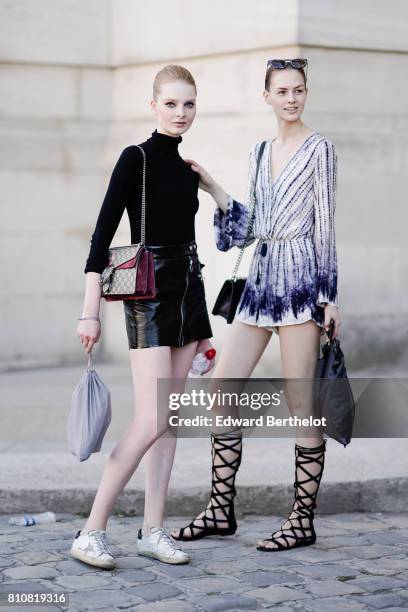 Model wears a black turtleneck top, a Gucci bag, a black shiny skirt, white sneakers ; a model wears a low-neck blue and white striped dress, lace-up...