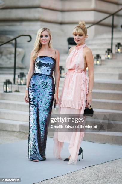 Guest wears a silver shiny dress ; a guest wears a pink ruffled dress, outside the amfAR dinner at Petit Palais, during Paris Fashion Week - Haute...