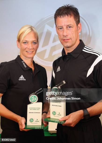 Referees Bibiana Steinhaus and Wolfgang Stark pose with the award trophy after been awarded as referee of the year 2017 on July 8, 2017 in Grassau,...