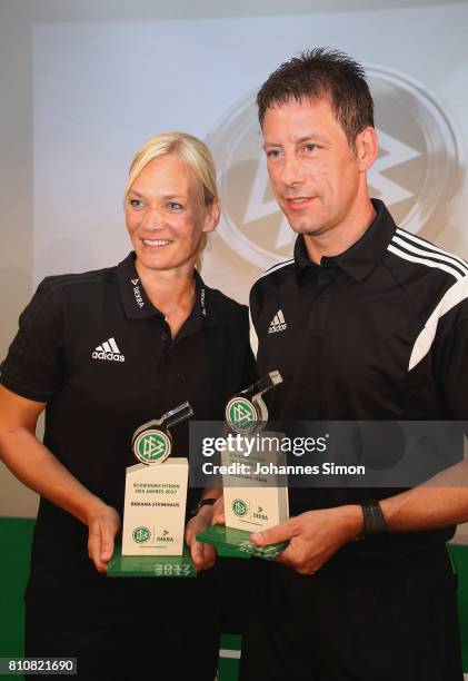 Referees Bibiana Steinhaus and Wolfgang Stark pose with the award trophy after been awarded as referee of the year 2017 on July 8, 2017 in Grassau,...