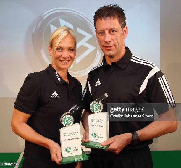 Referees Bibiana Steinhaus and Wolfgang Stark pose with the award trophy after been awarded as referee of the year 2017 on July 8, 2017 in Grassau,...