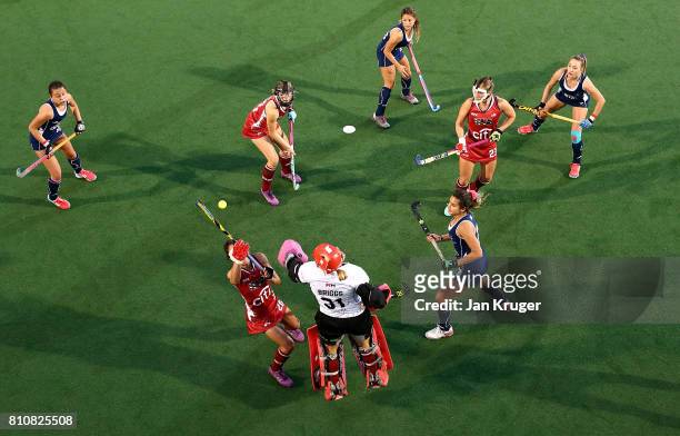 Caitlin van Sickle and Jackie Briggs, goalkeeper of United States of America blocks a shot at goal during day 1 of the FIH Hockey World League Semi...