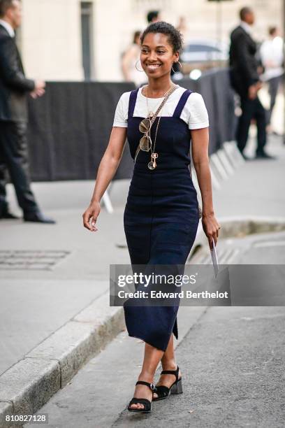 Guest wears a white t-shirt and a blue dress, outside the Valentino show, during Paris Fashion Week - Menswear Spring/Summer 2018, on June 21, 2017...