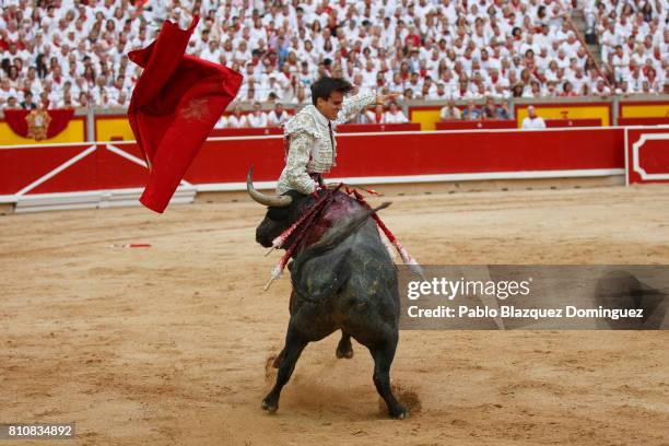 Bull from Jose Escolar Gil's fighting bulls tosses Spanish bullfighter Gonzalo Caballero during a bullfight on the third day of the San Fermin...