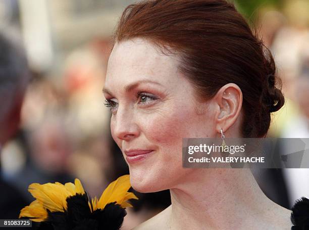 Actress Julianne Moore poses as she arrives to attend the opening ceremony and the screening of Brazilian director Fernando Meirelles' film...