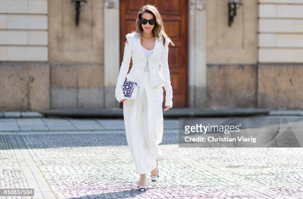 Model and fashion blogger Alexandra Lapp wearing culottes and blazer from Michalsky in white, Celine Audrey sunglasses, Roger Vivier satin sling-back...