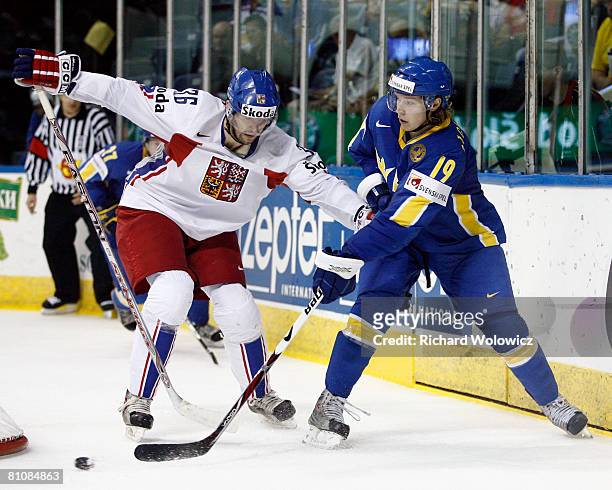 Nicklas Backstrom of Sweden passes the puck while being followed by Petr Caslava of the Czech Republic during the IIHF World Ice Hockey Championship...