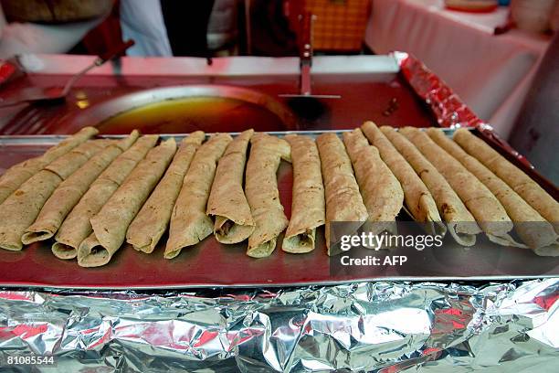 Row of Tacos Dorados on display by a "comal" at a street stand in Mexico City on 14 May, 2008. Wine expert Alejandro Zarate proposes to taste the...