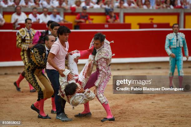 Spanish bullfighter Miguel Abellan and other bullfighters carry Spanish bullfighter Gonzalo Caballero after he was tossed by a bull from Jose Escolar...