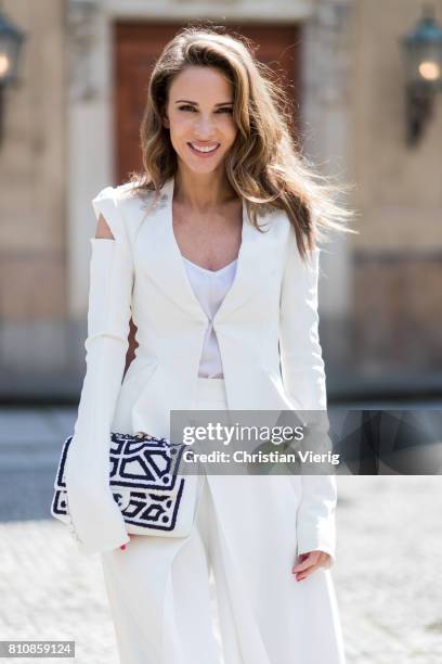 Model and fashion blogger Alexandra Lapp wearing culottes and blazer from Michalsky in white, Celine Audrey sunglasses, Roger Vivier satin sling-back...